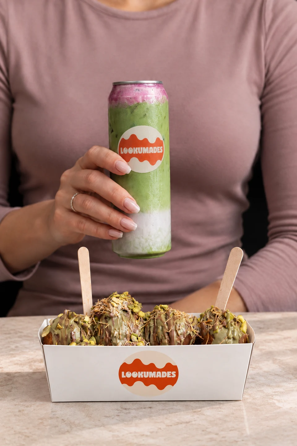 Iced matcha and pistachio loukoumades in white Lookumades packaging