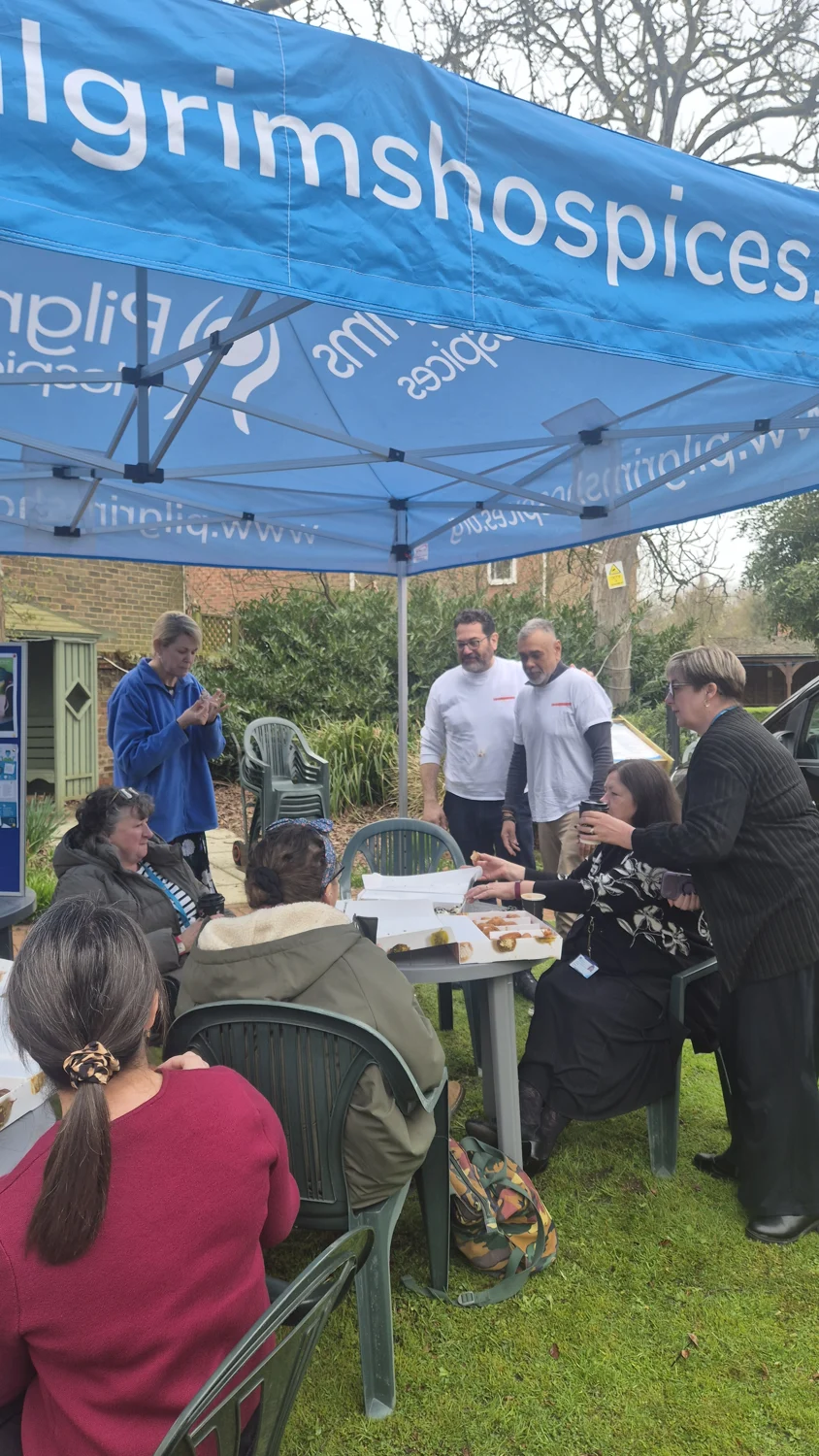 Adam and Cliff with a group enjoying Loukoumades at Pilgrims Hospice