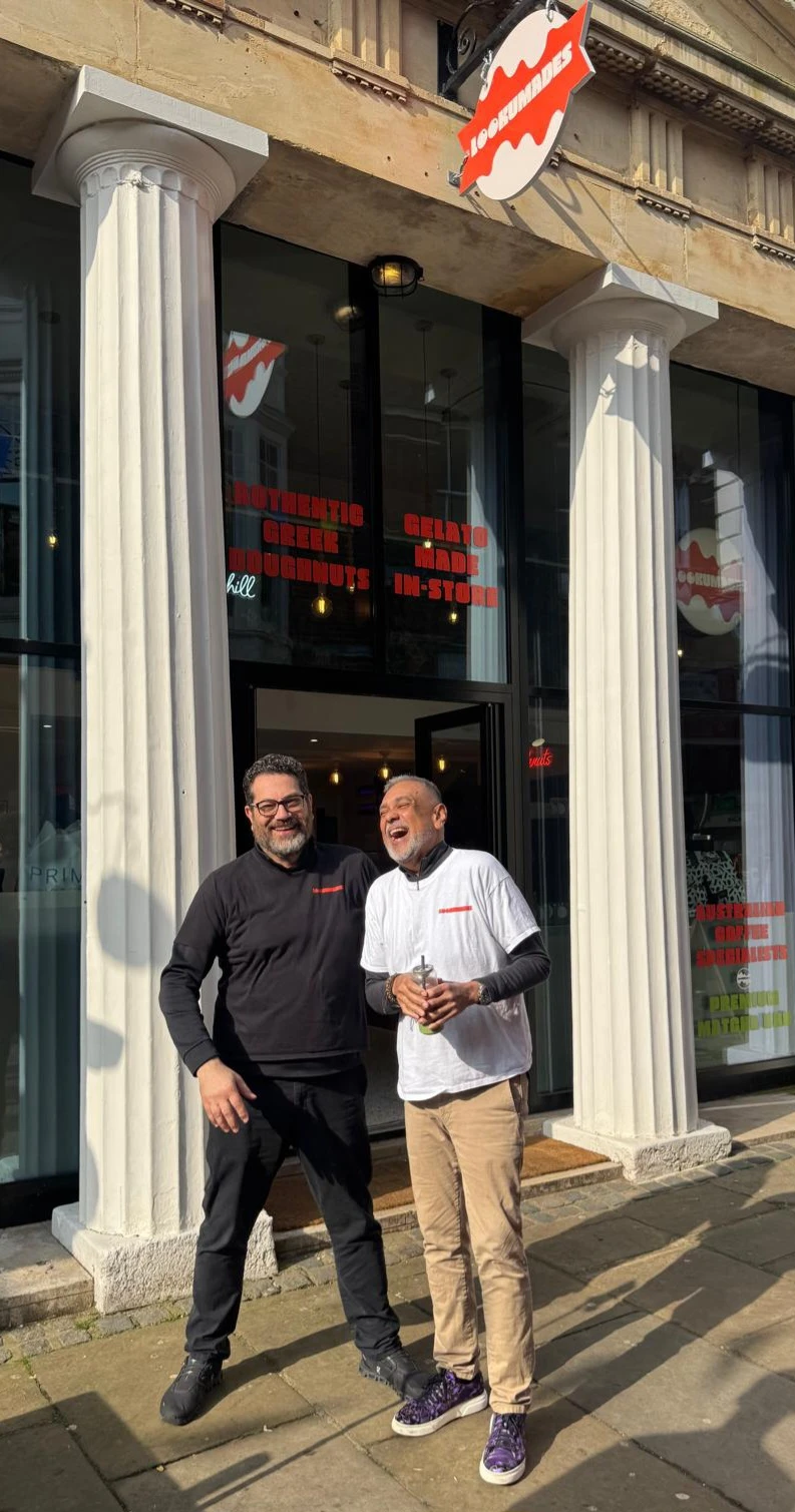Adam and Cliff laughing together outside the Lookumades Canterbury store